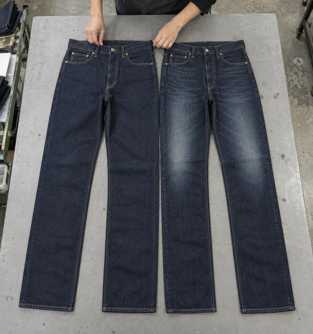 Clean rinse and distressed jeans arranged side by side on a sampling table