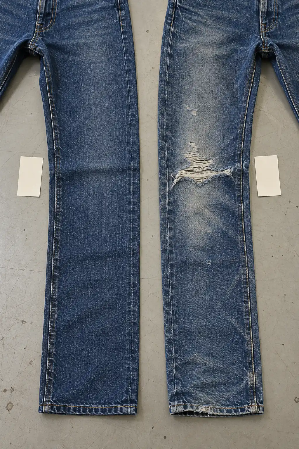 Clean and distressed denim legs laid side by side for fit and damage placement comparison