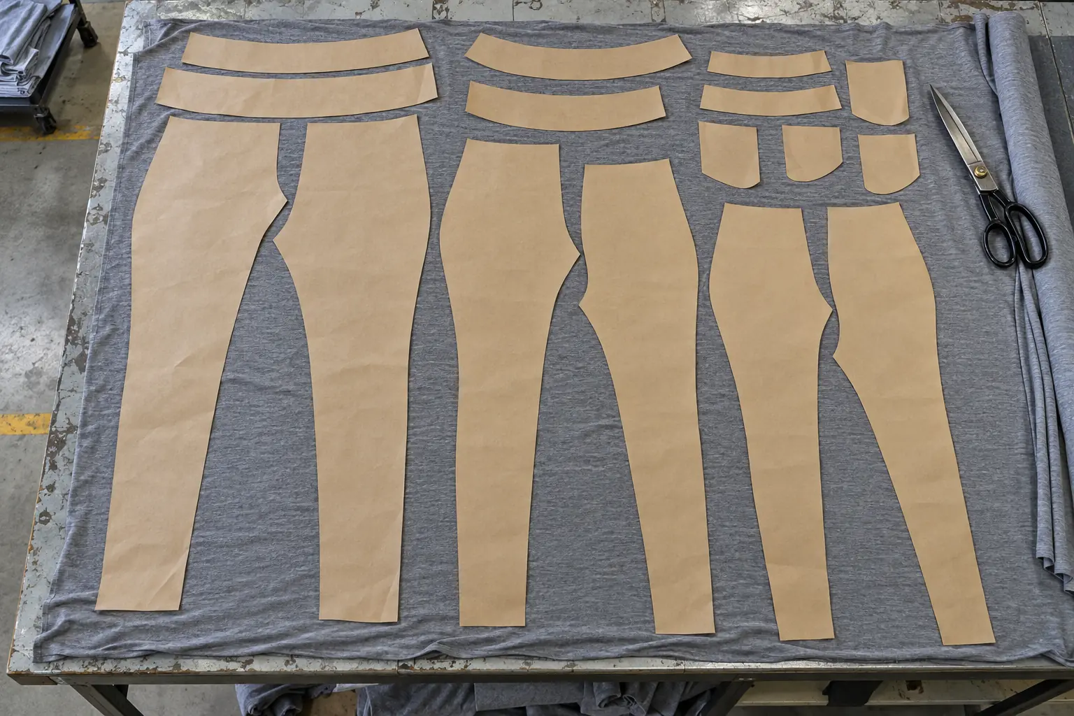 Legging pattern pieces arranged on plain fabric at a sampling table