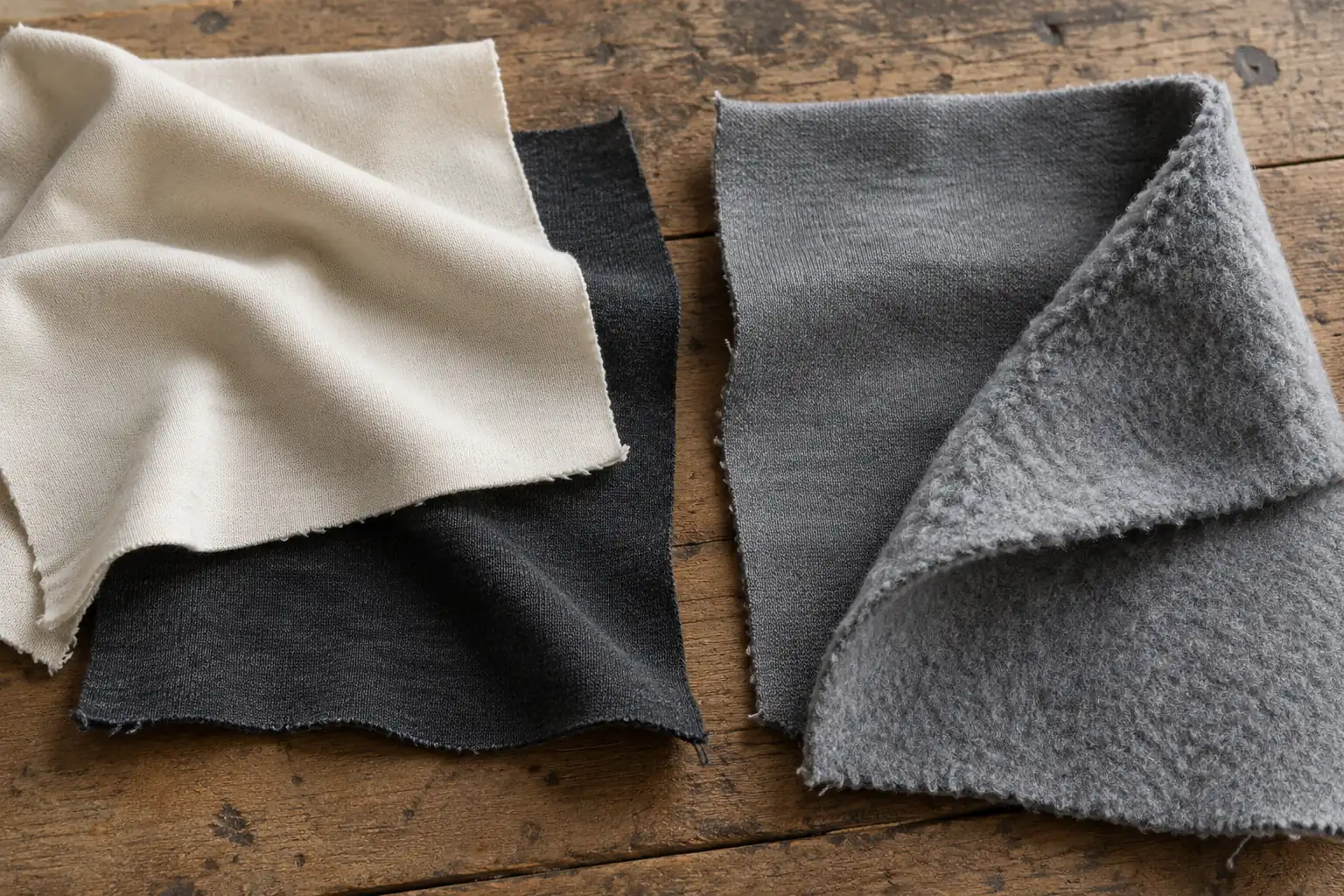 Cotton jersey and fleece swatches grouped into a restrained collection palette