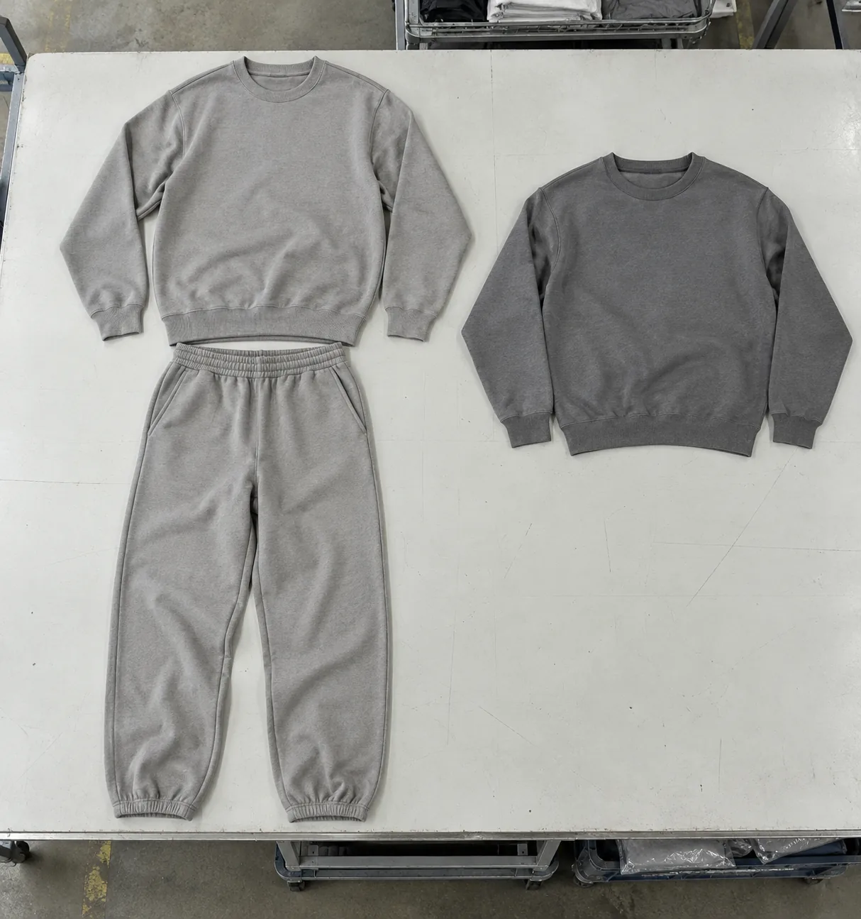 Unbranded coordinated sweatshirt and trousers arranged beside a standalone sweatshirt