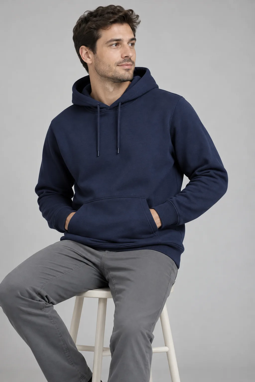 Fit model testing hand entry into a plain hoodie pocket during a sample review