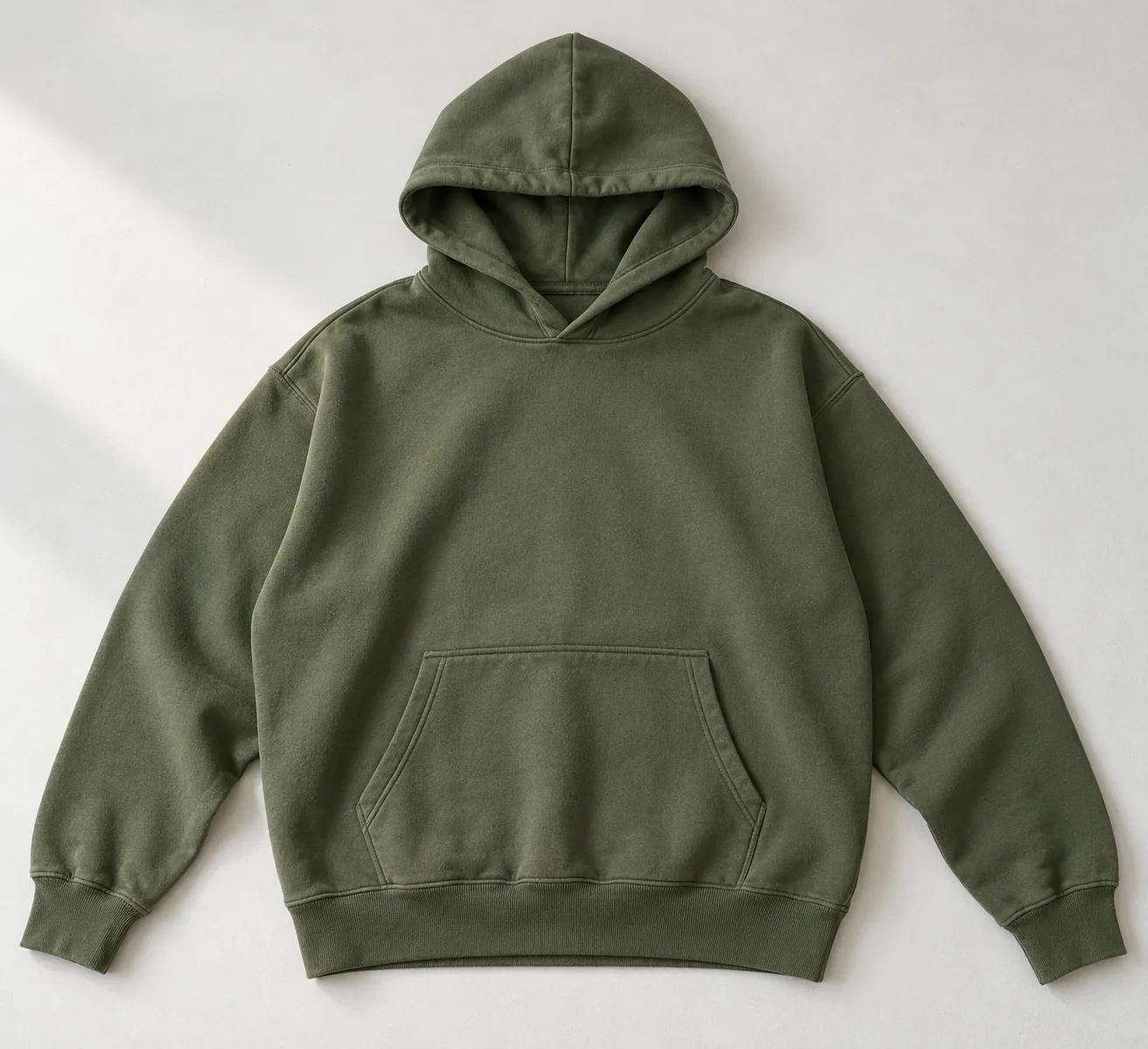 Finished hoodie laid flat with its cuffs and waistband visible